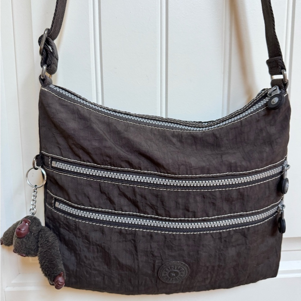 Kipling Alvar Brown Zip Crossbody Bag with Charm. 12” by 10” by 1”
